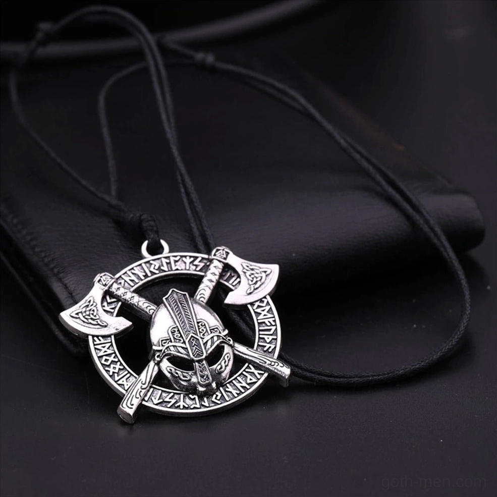 Norse rune warrior pendant with crossed axes and helmet on black leather background