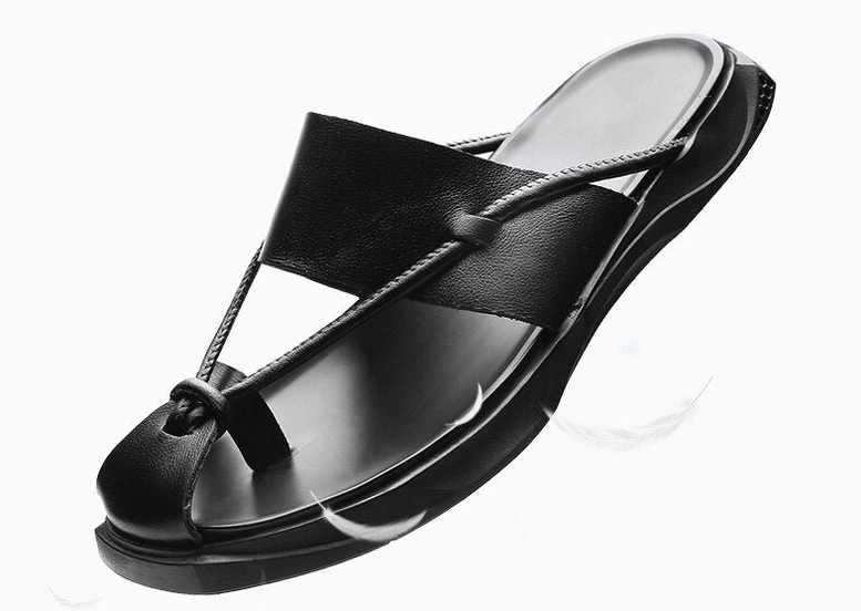 Side profile of black leather gothic sandals showing knotted toe strap and flexible rubber sole