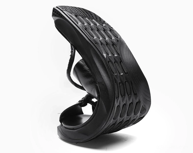 Bottom three-quarter view of gothic ankle-wrap sandals demonstrating sole flexibility and construction