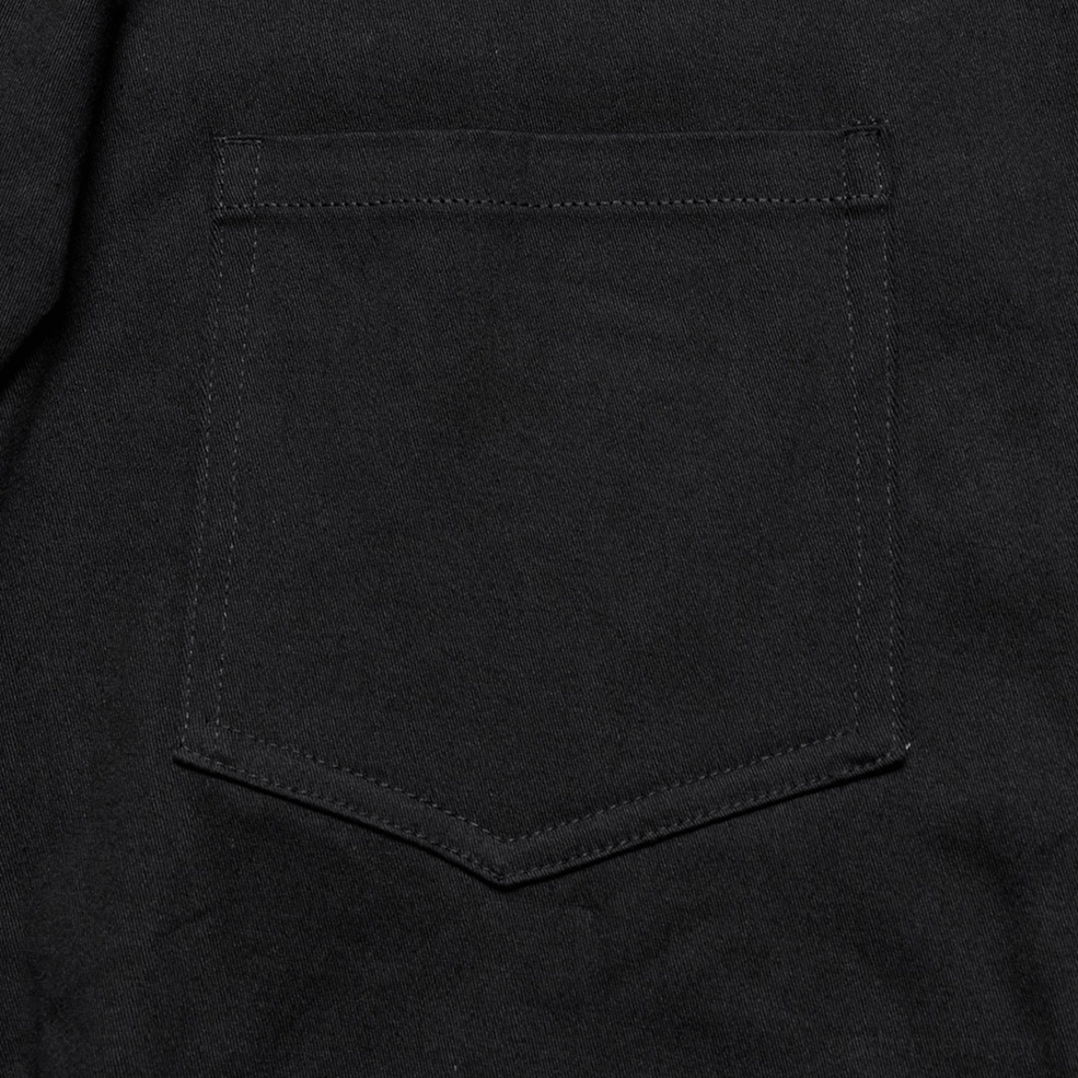 Detailed close-up of black gothic shirt stitched square chest pocket twill fabric finish and construction