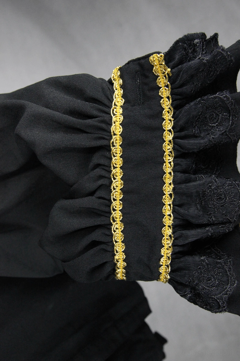 Detailed front view of black ruffled cuff with double gold braid trim on gothic men's shirt