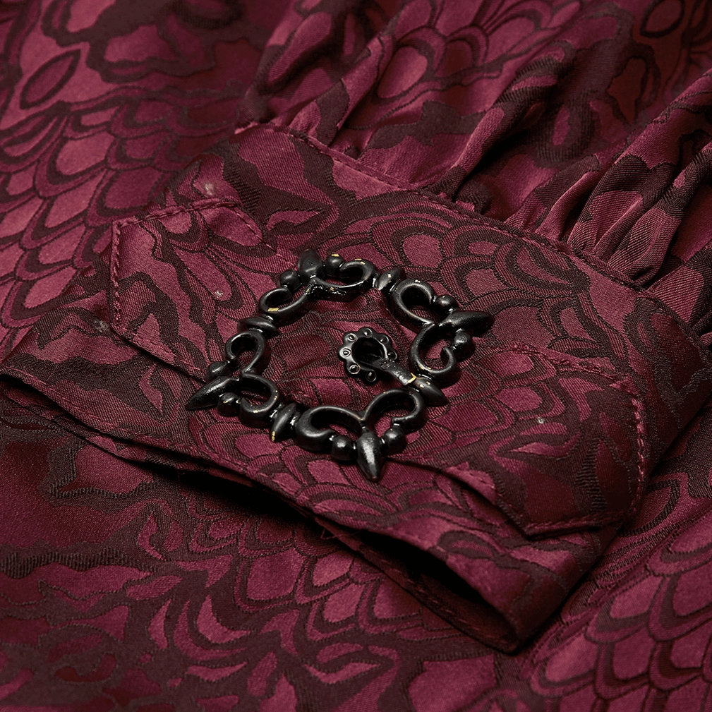 Close-up detail of gothic shirt cuff featuring ornate dark metal square buckle with gathered burgundy jacquard fabric
