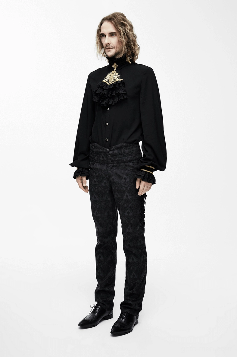 Close-up texture detail of black gothic shirt with embroidered gold patterns and baroque elements