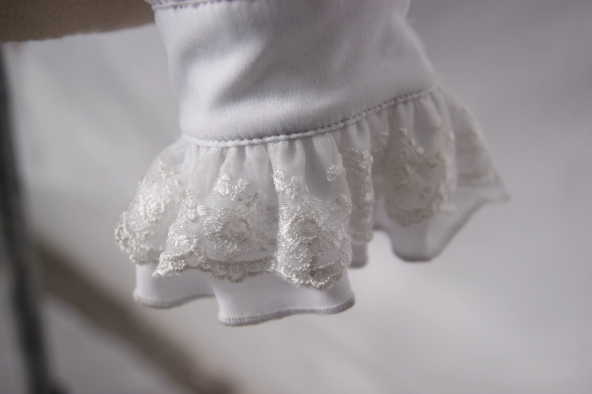 Close-up detail of white lace ruffled cuff trim on gothic formal dress shirt