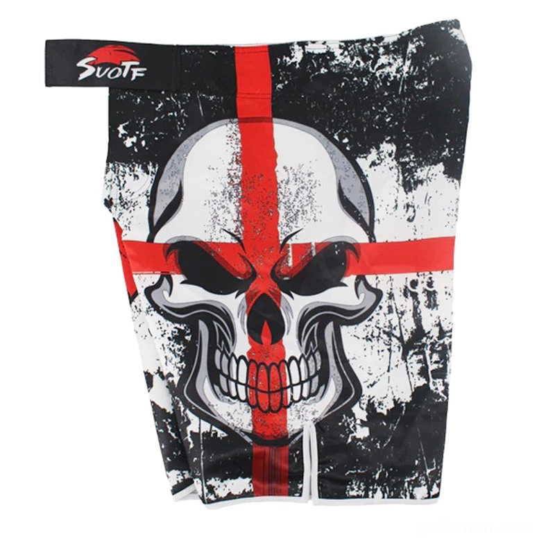 Flat lay detail view of gothic shorts waistband and bold skull cross print with official brand tag and exposed elastic