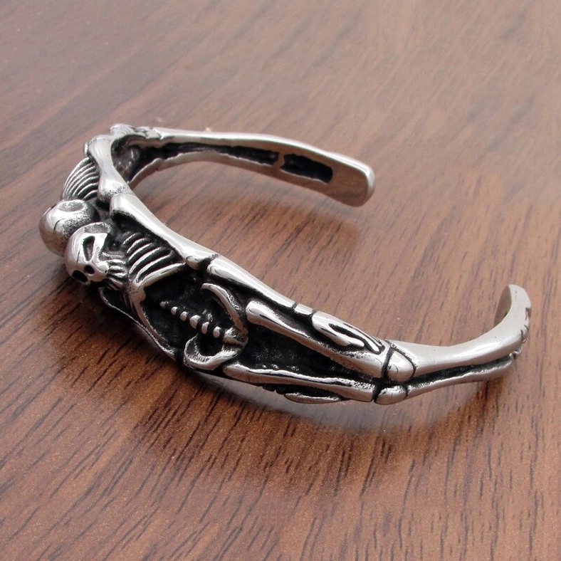 Three-quarter side view of gothic skeleton cuff bracelet highlighting rib cage and skull motifs – unisex alternative jewelry