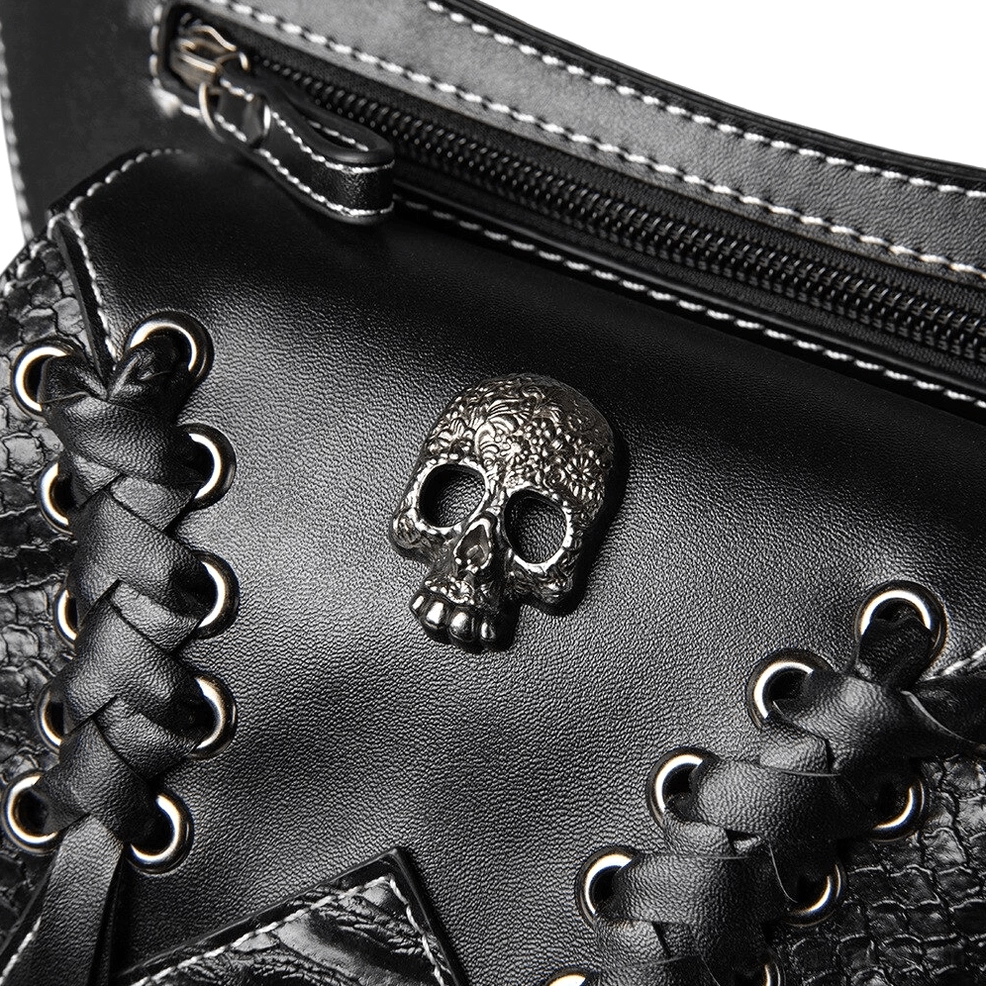 Macro close-up of skull metal decoration lace grommets and zipper closure on gothic leather bag