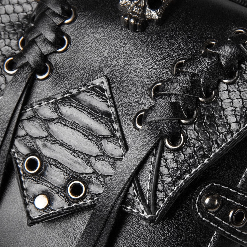 Detail shot of snakeskin textured leather panels lace straps and metal rivets on gothic thigh bag