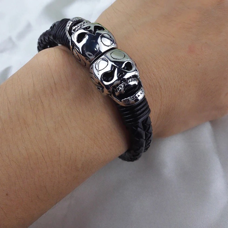 Man wearing black braided leather skull bracelet on wrist, lifestyle product shot