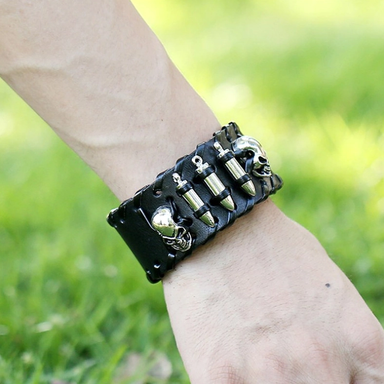 Gothic skull leather bracelet worn on wrist outdoors, close-up showing punk-inspired metal elements and authentic wear styling