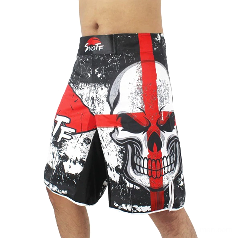 Front left view of black gothic skull cross training shorts with red multi-color print and distressed texture worn on male model