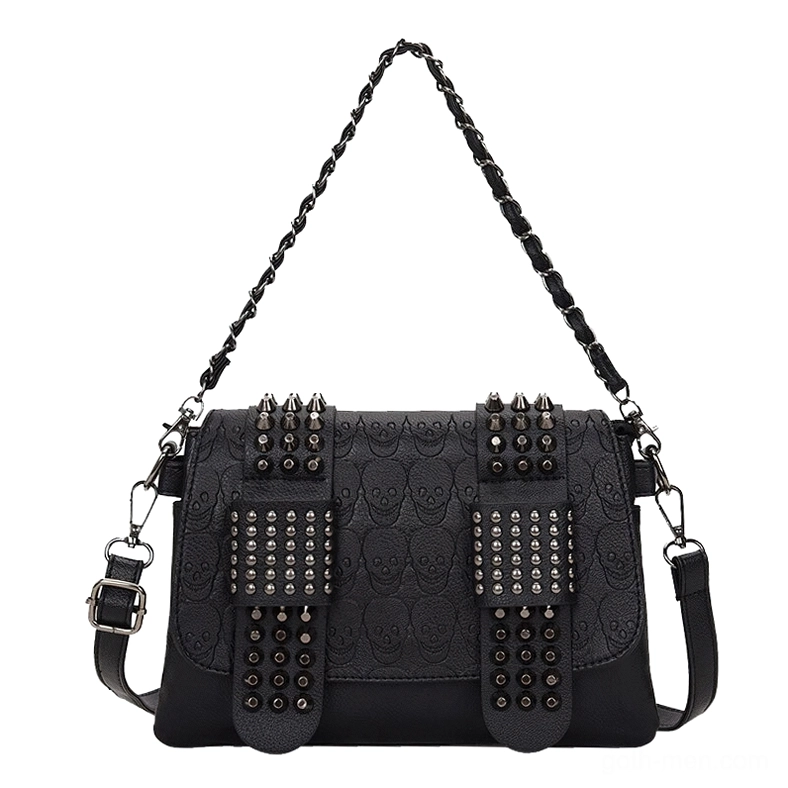 Skull embossed gothic crossbody bag front flat view with double riveted straps, pure white background