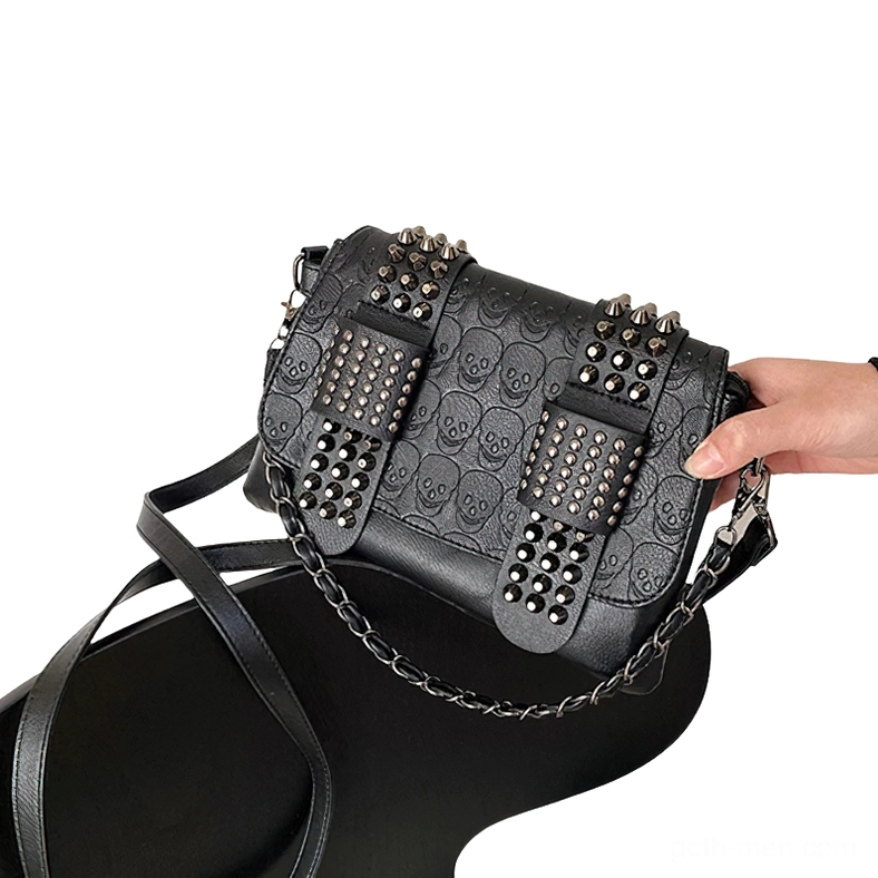 Skull embossed gothic crossbody bag side oblique view with clear embossed texture on dark background