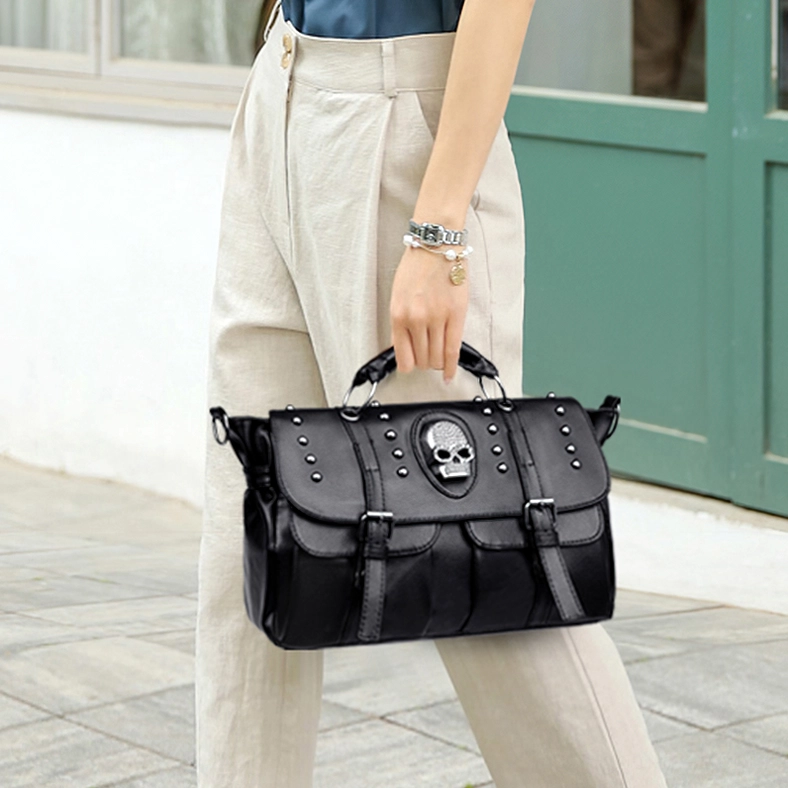 Woman carrying gothic skull leather handbag as top handle tote with casual outfit at doorway