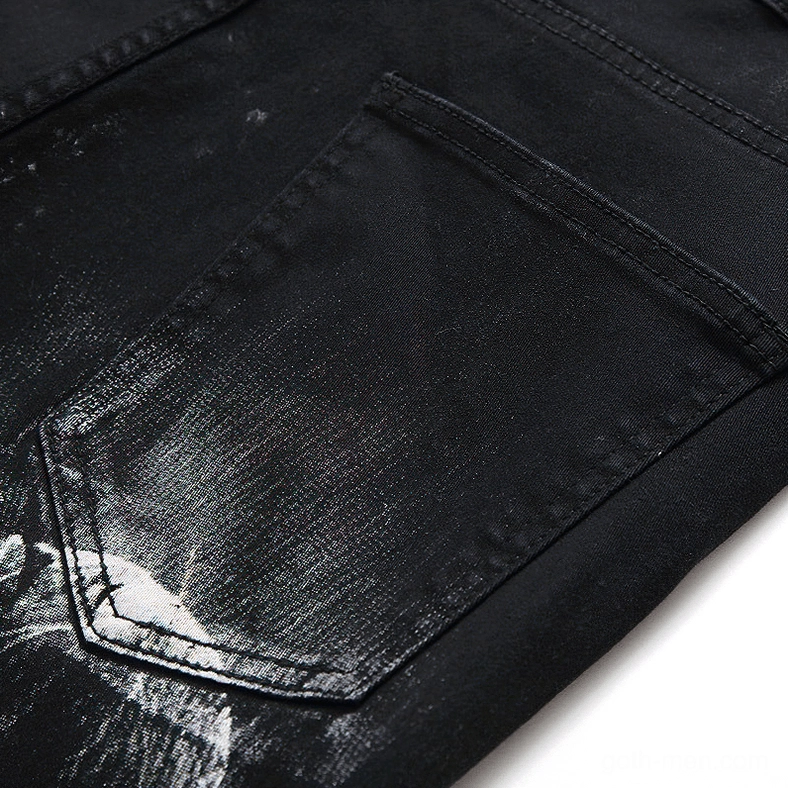 Black denim back pocket close-up with standard jean construction and subtle printed marks