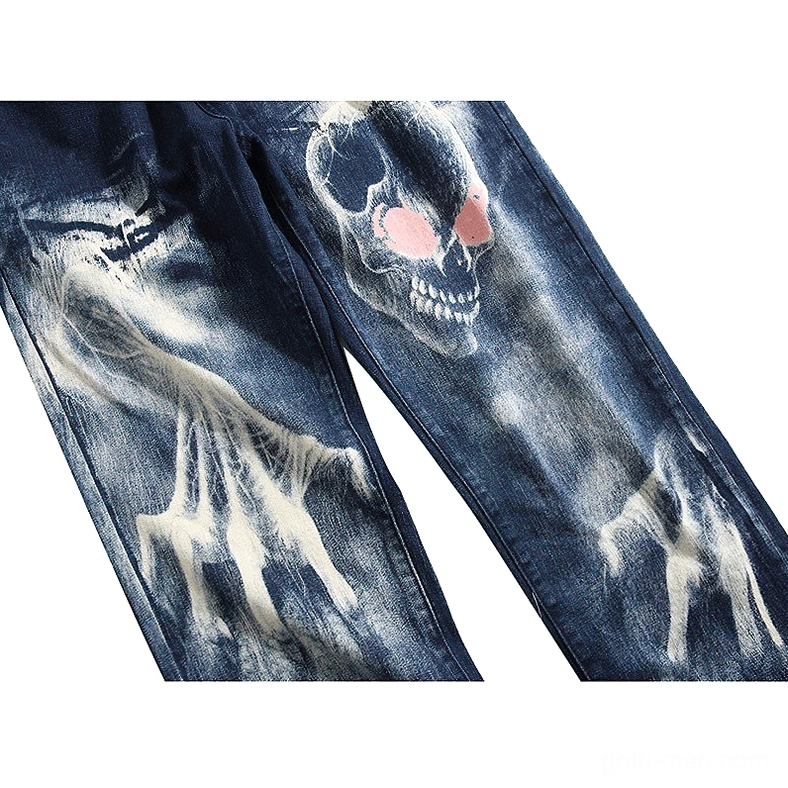 Blue denim jeans close-up of pink-eyed skull print with ghost hand bleached effect