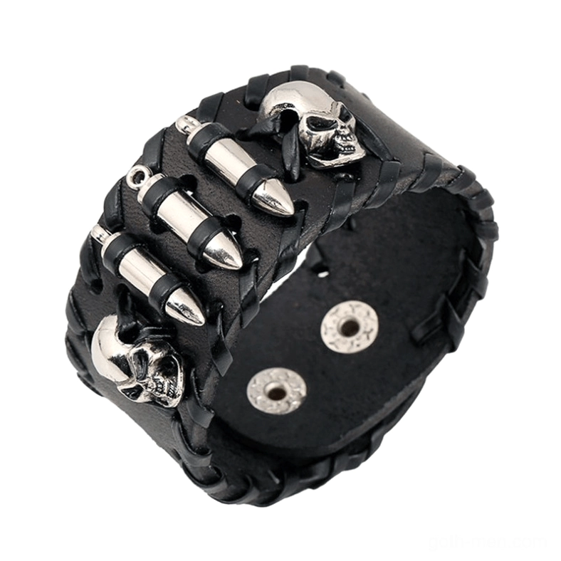 Black braided leather gothic skull bracelet with silver metal skull charms and bullet studs, overhead studio view showing detailed punk-inspired design