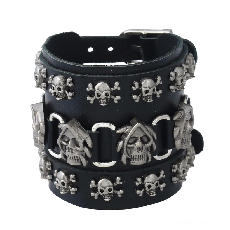 Antique silver skull leather cuff bracelet for men with multiple skull charms and wide genuine leather strap, overhead view