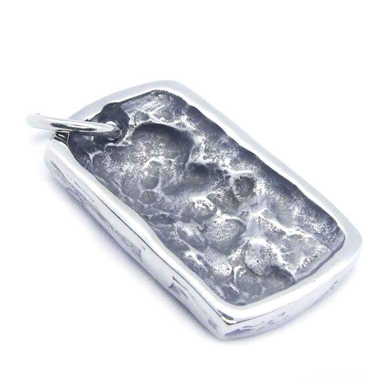 Back side view of weathered ghost skull dog tag pendant showing textured uneven surface finish in silver tone