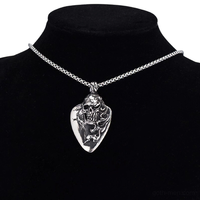 Gothic skull pendant worn on black jewelry mannequin torso, close-up detail of carved design