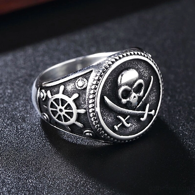 Silver-tone gothic skull and crossed swords ring with ship wheel decoration on band, side profile view