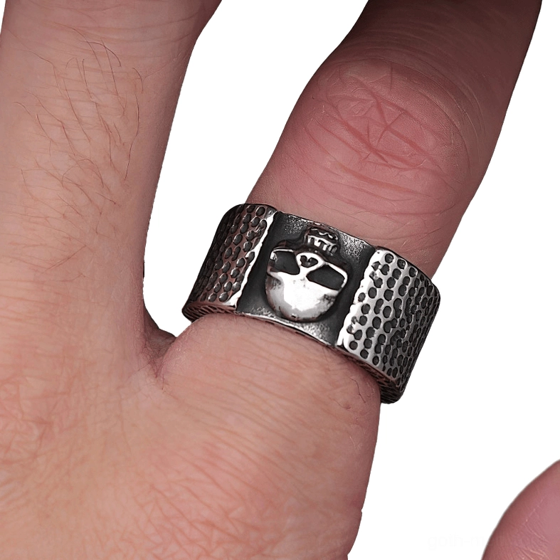 Crowned skull gothic ring on finger close-up showing hammered band design and craftsmanship