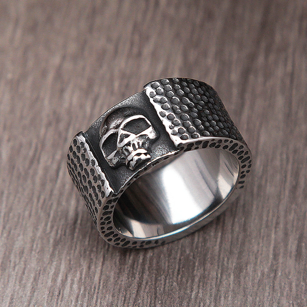 Cross-eyed skull gothic ring top oblique view showing hammered dot pattern metalwork