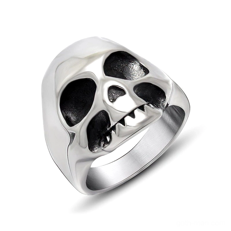 Gothic skull ring with carved fangs and hollowed eye sockets, polished silver stainless steel memento mori design, front three-quarter view