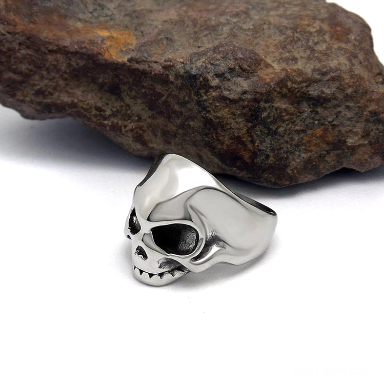 Punk rock skull ring side profile, stainless steel skeleton band with detailed facial features, gothic alternative jewelry side angle