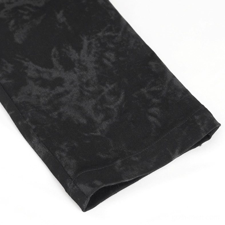 Detailed close-up of tapered trouser hem showing dark marble-like printed fabric and slim cut