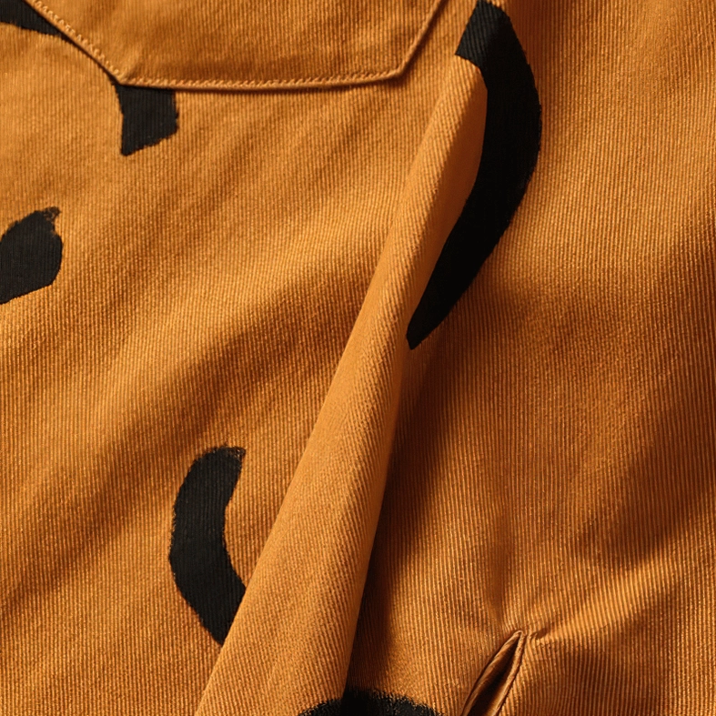 Overhead flat lay of multiple gothic smiley print shirts, size and color comparison, all three variant bases