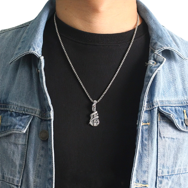 Male model wearing unisex gothic rock snake guitar pendant with denim jacket