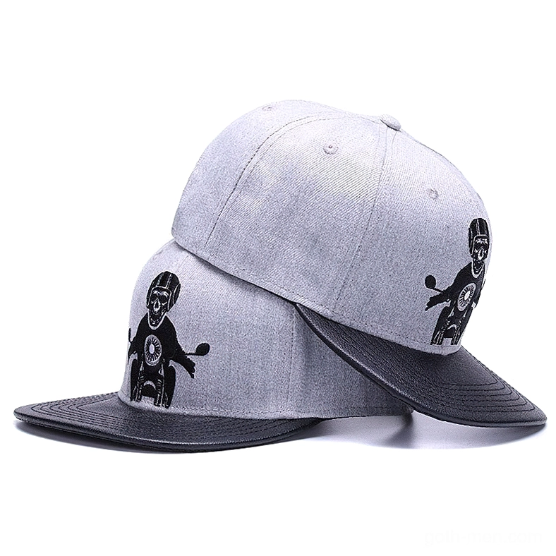 Multiple grey gothic baseball caps stacked side by side displaying embroidered skull rider motorcycle motif