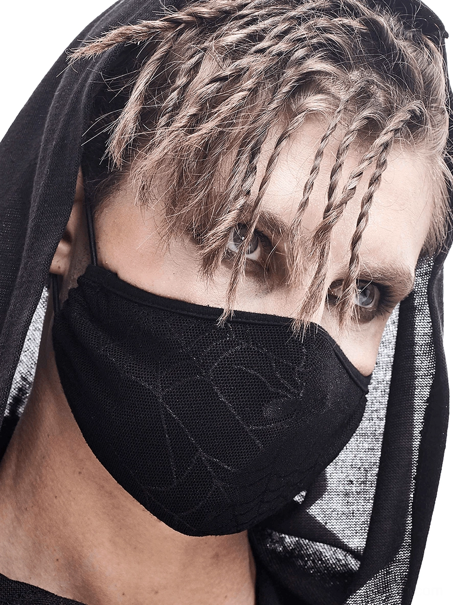 Male model with dreadlocks wearing breathable black spiderweb gothic face mask, close-up front view studio shot