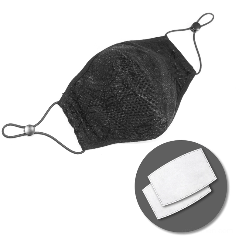 Black spiderweb gothic mask with removable filter inserts, side flat lay view, contoured shape