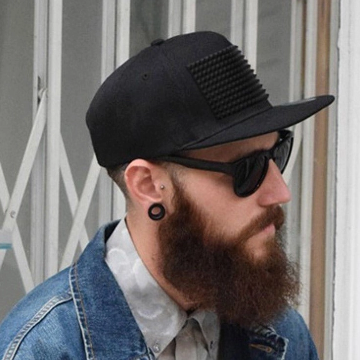 Spike snapback cap worn by model in sunglasses and denim jacket, outdoor street style, gothic punk aesthetic