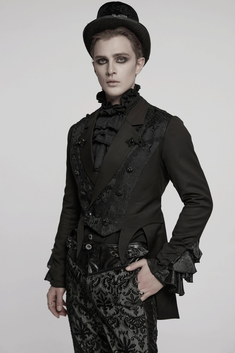 Gothic tailcoat jacket styled on model showing ruffled lace cuffs, peaked lapel construction, and double-breasted button placement