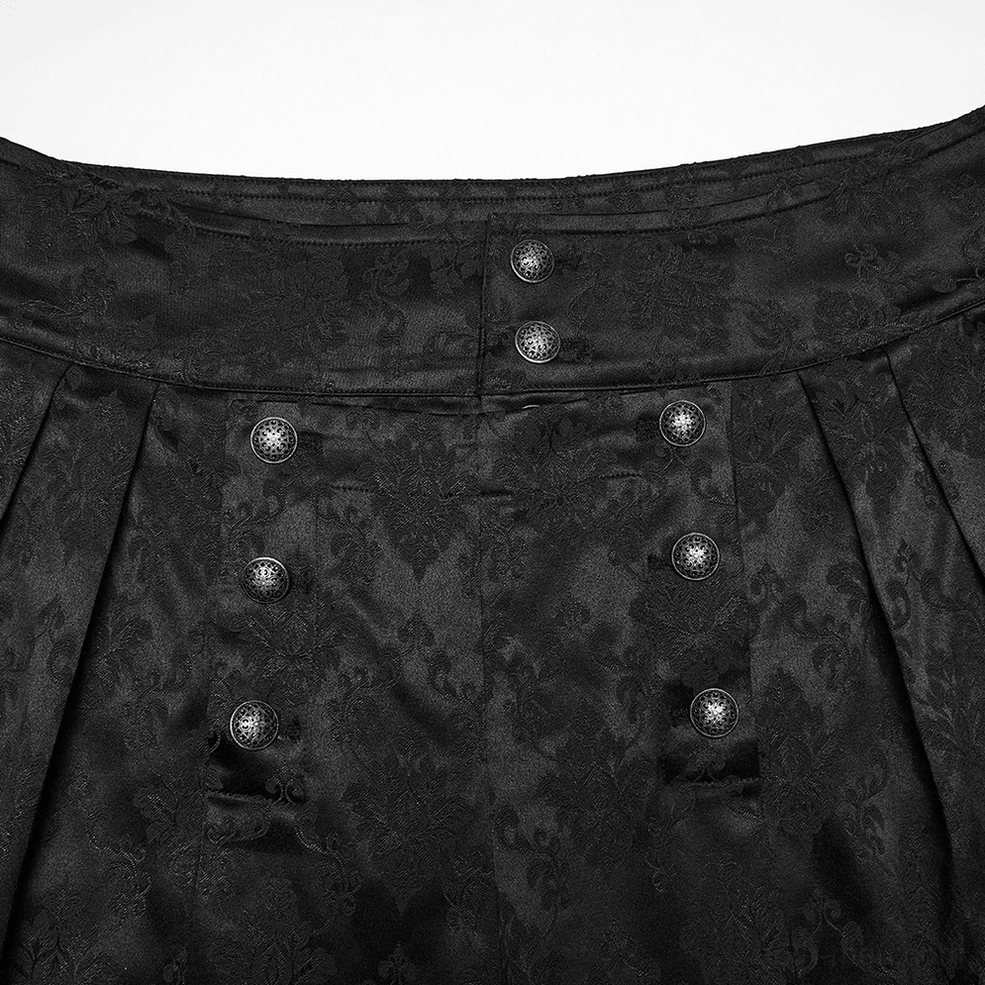 Close-up of black gothic tapered trousers waist showing double-row metal buttons and front pleats