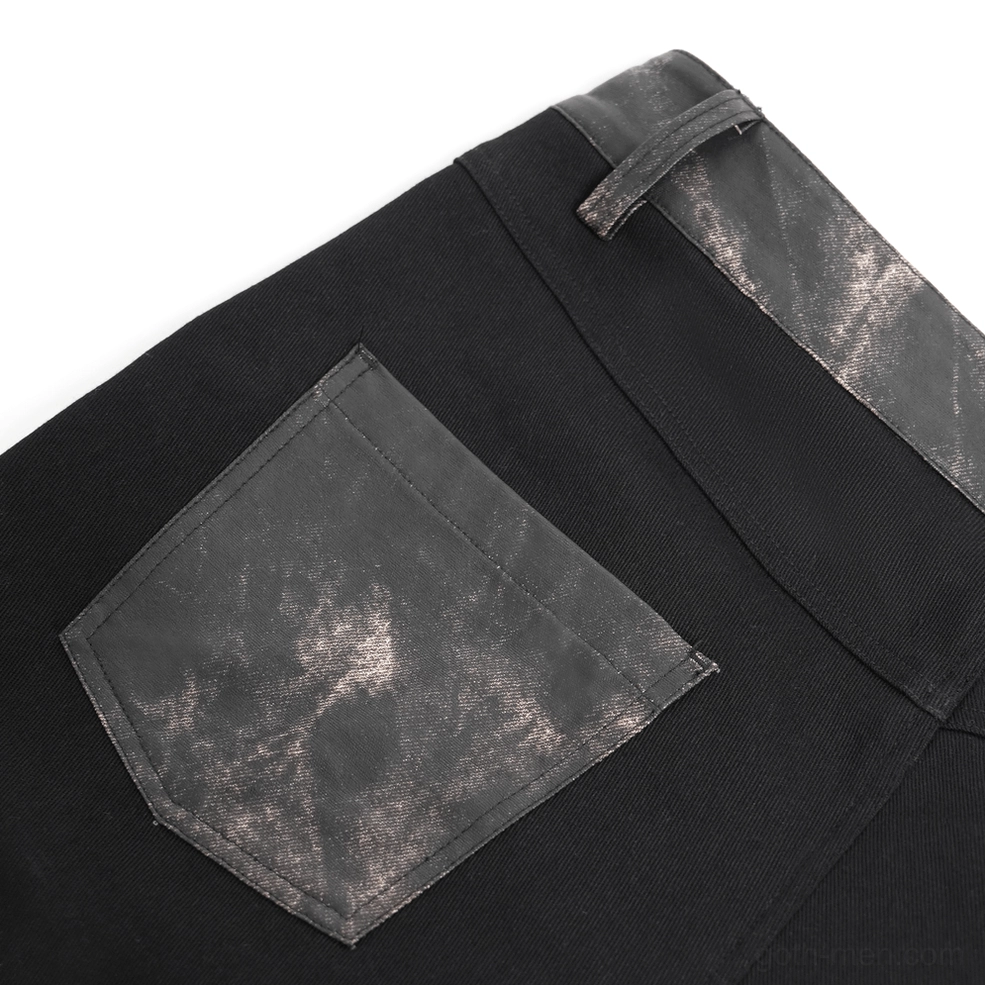 Black gothic leather pants showing industrial rivet placement and punk rock aesthetic details