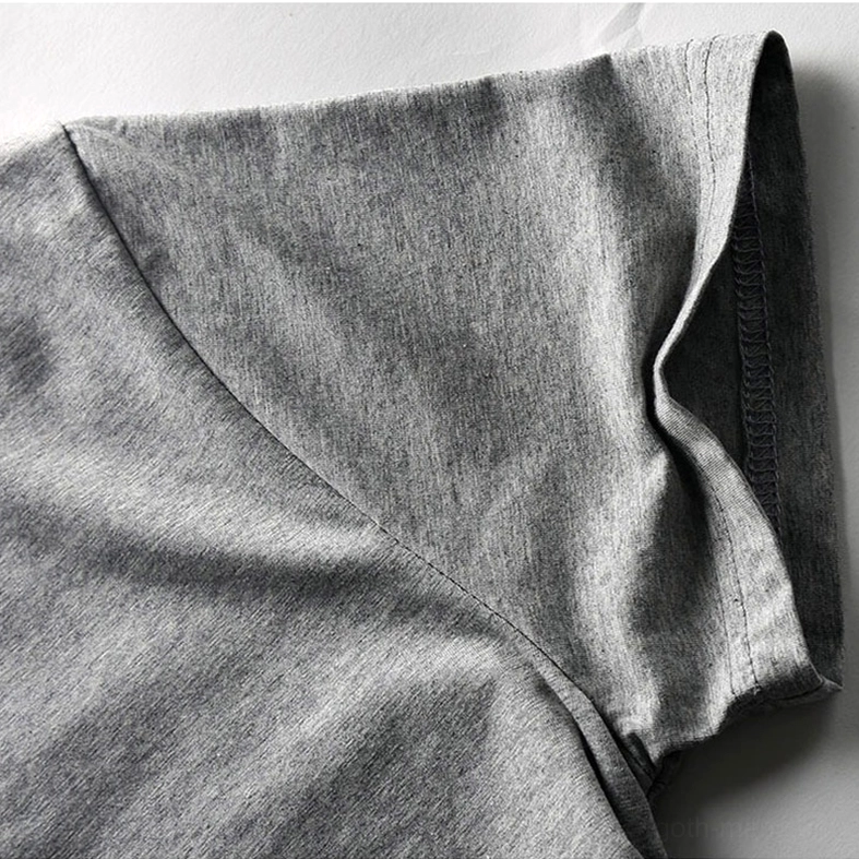 Gothic T-shirt fabric texture close-up showing heathered weave and quality stitching