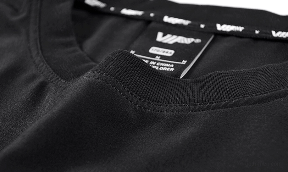 Close-up of ribbed crew neckline with branded inner tape detail on black oversized gothic tee
