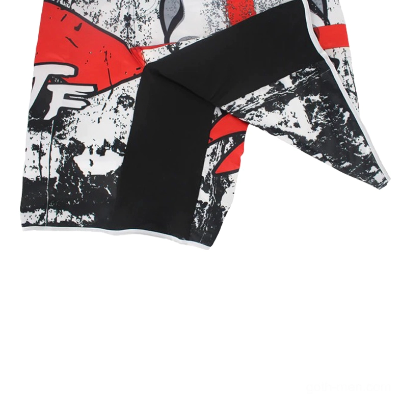 Flat lay full view of black athletic gothic shorts featuring multi-color red and white skull cross design with distressed finish
