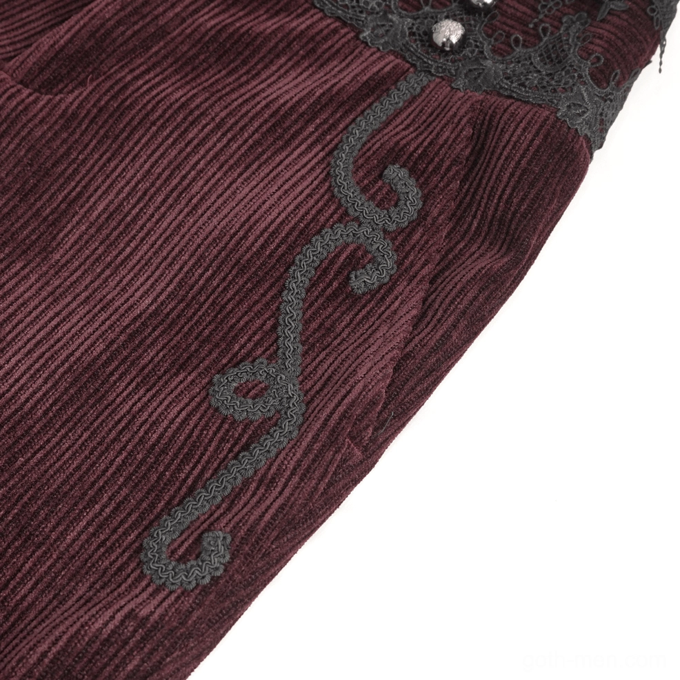 Detailed side view of black lace trim and scroll embroidery on wine red gothic corduroy trousers waistband