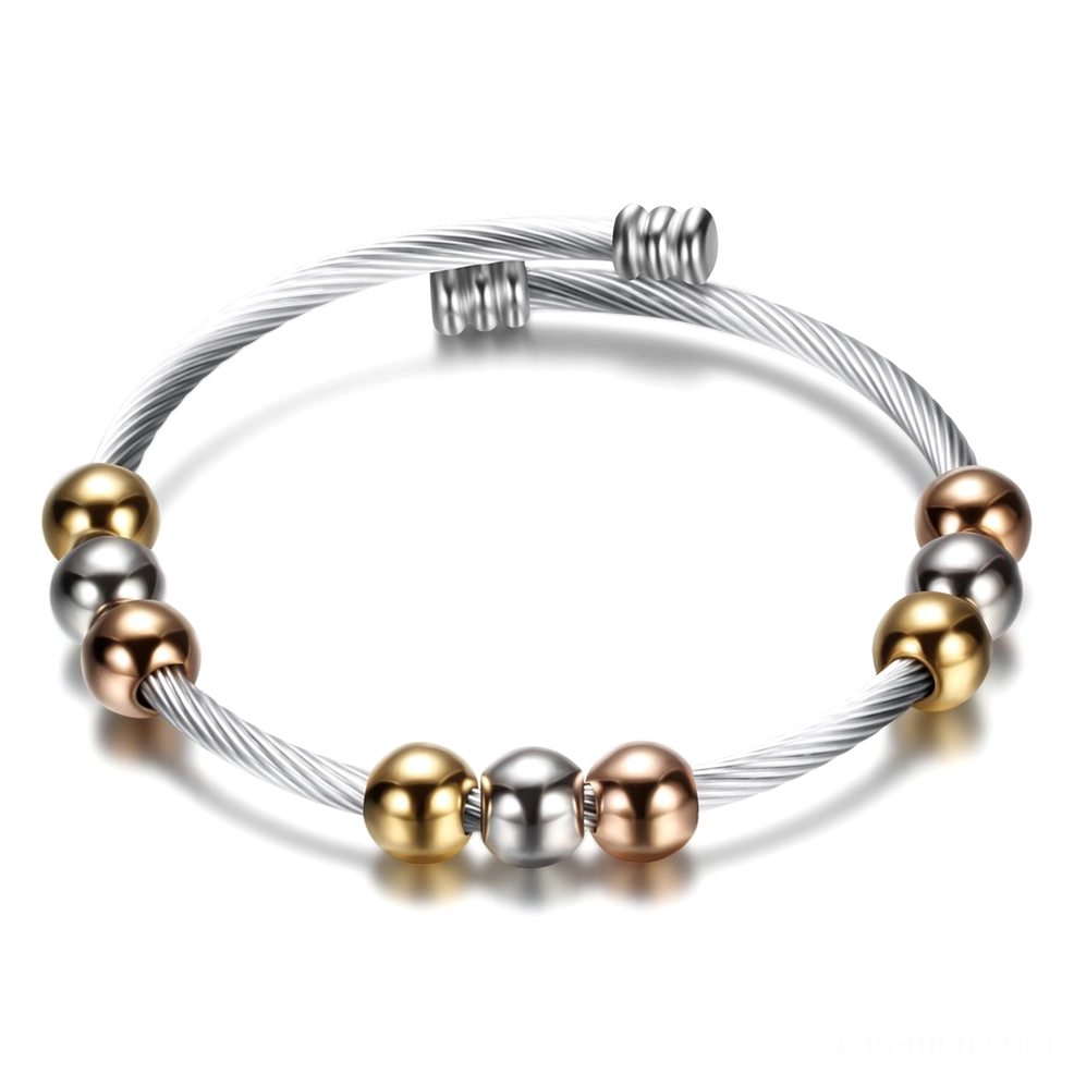 Two-tone gothic twist cuff bracelet with mixed metal beads flat lay overhead view