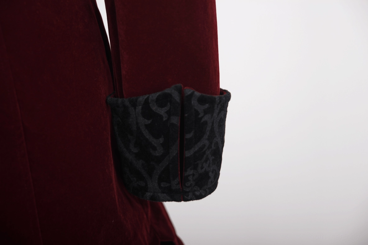 Close-up detail of burgundy gothic velvet coat cuff with split embroidered design