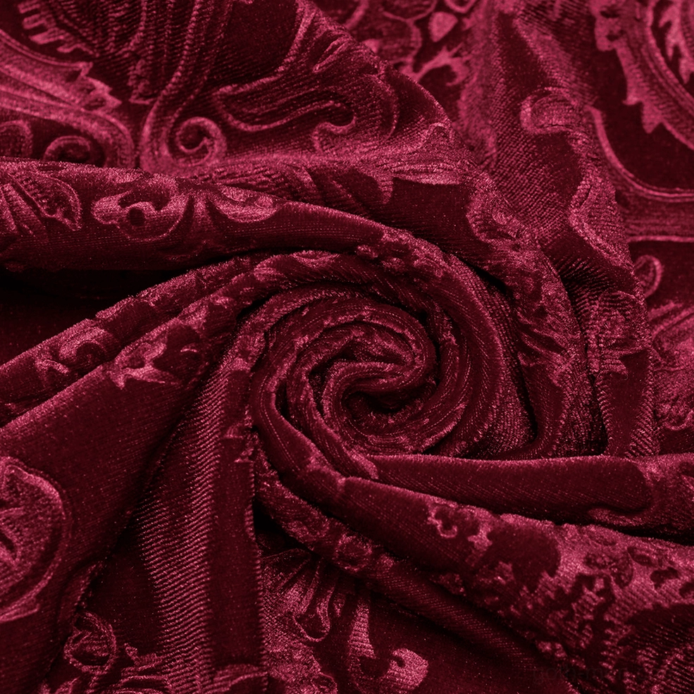 Detailed close-up view of red velvet gothic shirt cuff showing black button closure and embossed floral pattern