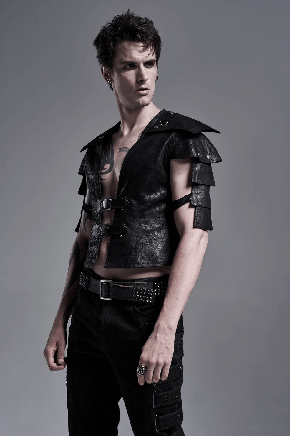Black leather gothic vest paired with band tee and dark jeans for concert wear look