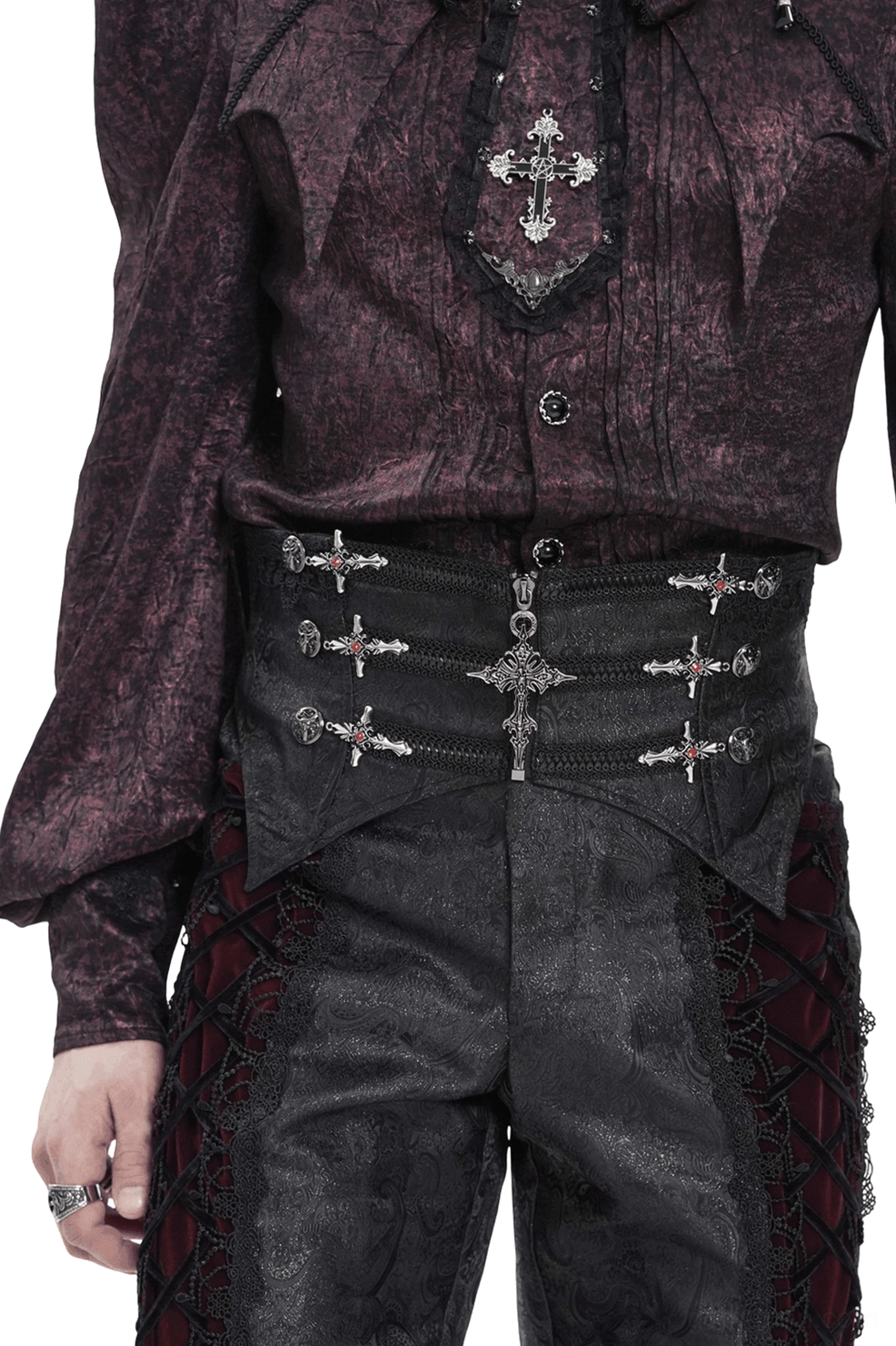 Male model wearing black brocade gothic waist corset with silver cross ornaments, front upper view, styled with dark purple gothic top in studio lighting