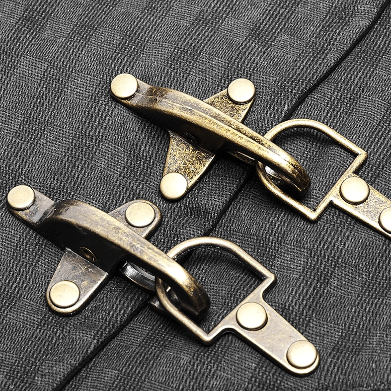 Close-up detail of antique bronze dual hook fasteners on black gothic waistcoat checked fabric background