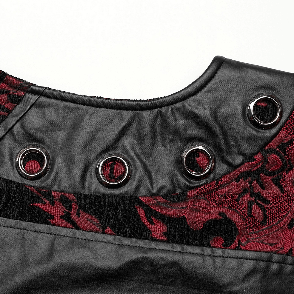 Close-up detail of gothic waistcoat hardware and trim, showing round metal grommets, rubberized faux leather trim, and textured damask fabric weave in red and black